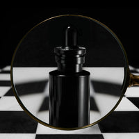 le serum infini in a magnifier glass on a chess board